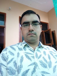 Portrait of young man standing at home