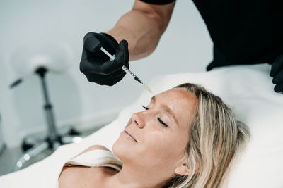 Young woman gets beauty facial injections in salon or clinic. skincare concept