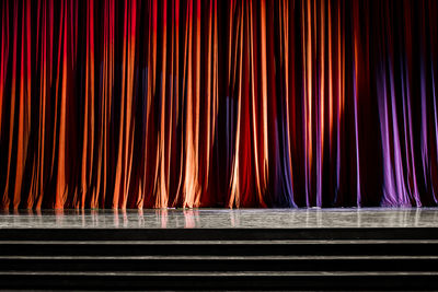 Illuminated light bulbs hanging from curtain