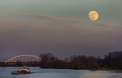 Scenic view of river against sky at sunset