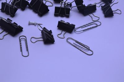 High angle view of paper clips on blue background
