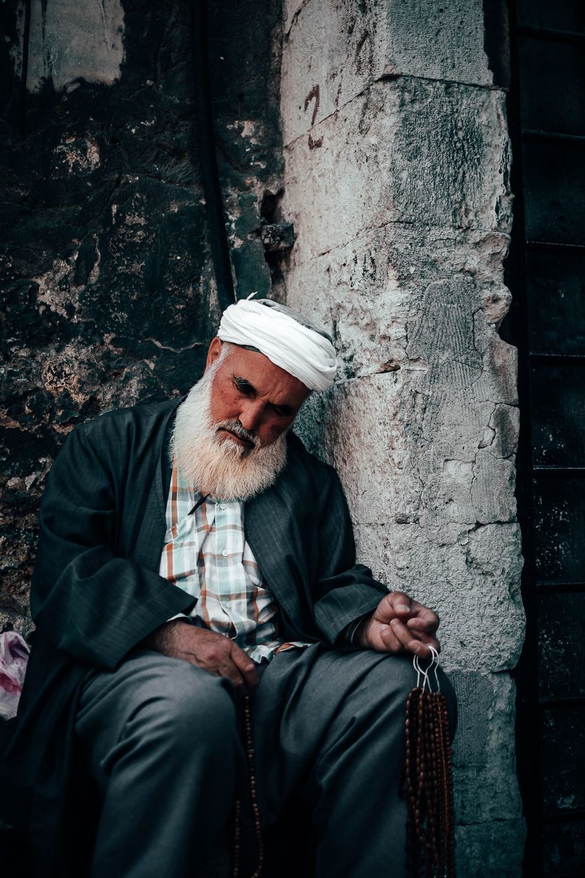 beard, facial hair, one person, men, males, sitting, real people, adult, senior adult, social issues, clothing, depression - sadness, hat, sadness, lifestyles, senior men, mature men, hopelessness, dirty, outdoors, unemployment, mustache