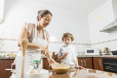 Woman and son cooking on table