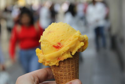 Close-up of hand holding ice cream cone