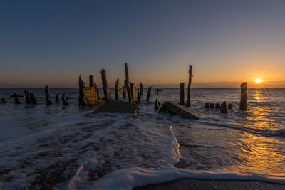 Scenic view of beach against sky during sunset