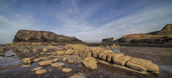 Scenic view of rock formations against sky