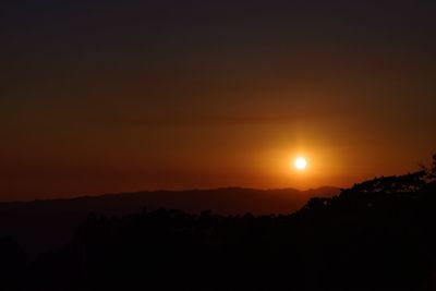 Scenic view of silhouette mountains against sky at sunset