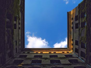 Low angle view of building against cloudy sky