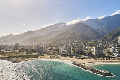 High angle view of townscape and mountains against sky