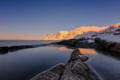 Scenic view of sea against clear sky during sunset