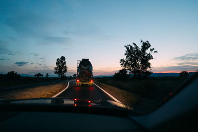 Road against sky seen through car windshield