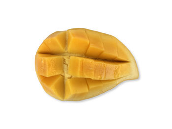 High angle view of yellow slices over white background