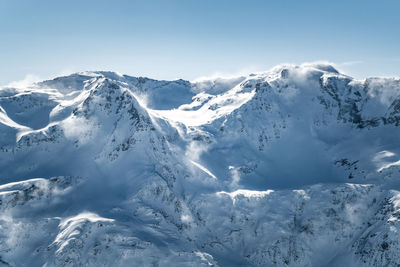 Scenic view of snowcapped mountains against sky