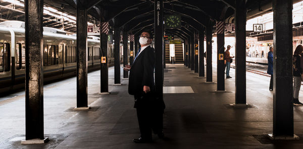 Portrait of man standing at railroad station