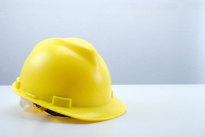 Close-up of yellow hat against white background