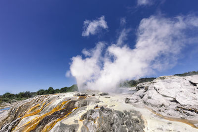 Panoramic view of volcanic mountain against blue sky