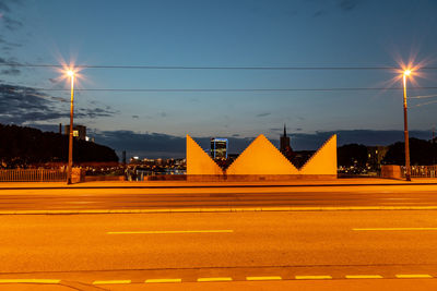 Light trails on road against sky at night