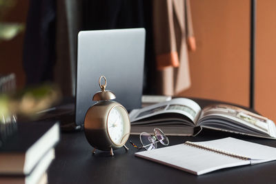 Laptop and businesses details on table, work place of designer