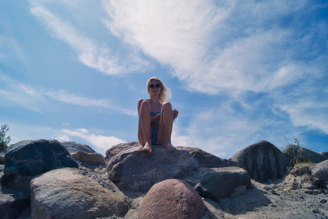 MAN SITTING ON ROCK