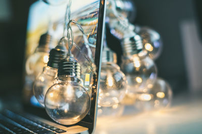 Close-up of illuminated light bulbs on laptop