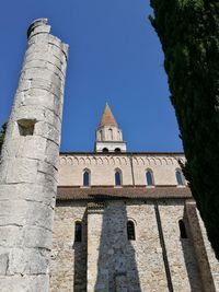 Low angle view of bell tower against blue sky