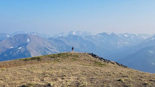 Man standing on mountain against clear sky