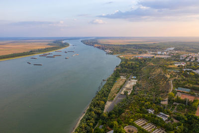 High angle view of sea and cityscape against sky