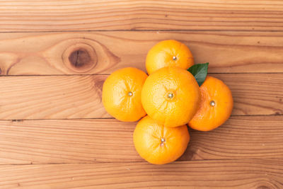 High angle view of oranges on wood