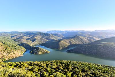 Scenic view of mountains against clear blue sky