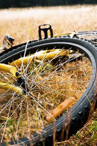 Close-up of bicycle wheel on field