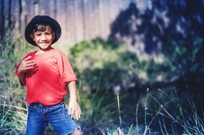 Portrait of boy standing on field