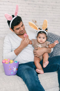 Father playing with daughter during easter egg