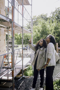 Female architect showing under construction apartment to customer