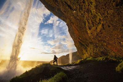 Chinese woman posing behind the waterfall seljalandsfoss