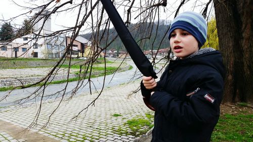 Boy wearing warm clothing while looking away at park