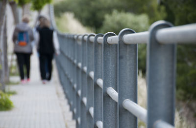 Close-up of woman walking on footbridge