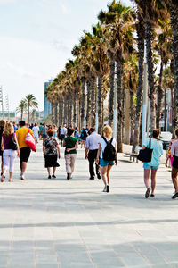 People walking on footpath against sky