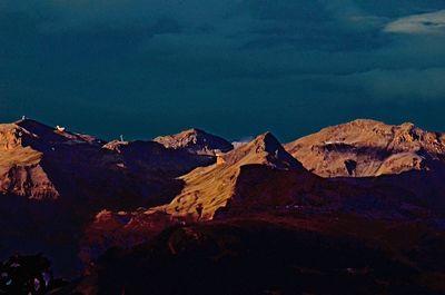 Scenic view of mountains against cloudy sky