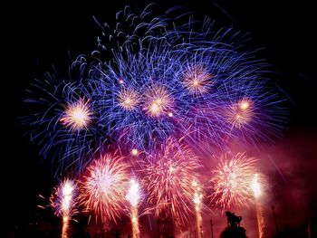 Low angle view of firework display at night