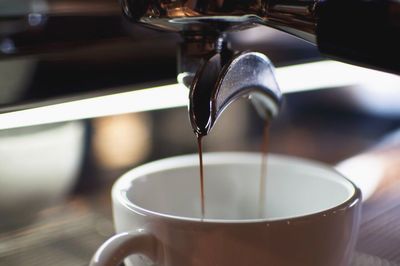 Close-up of pouring coffee in glass