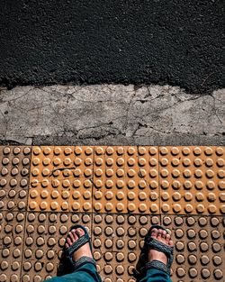 Low section of person standing on street