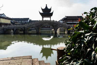 View of bridge and buildings against sky