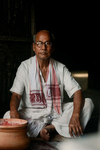 Portrait of senior man sitting at home