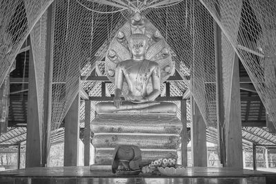 Buddha protected by serpent or naga statue in jaturamook sanctuary at wat analayo temple