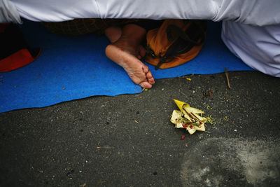 Low section of man lying on street