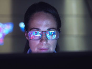 Engineer examining ai technology with reflection on eyeglasses