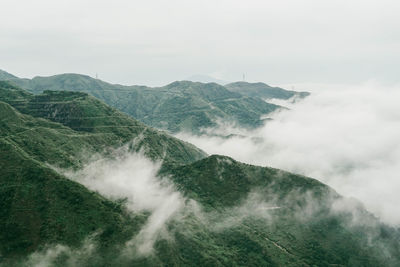 Scenic view of waterfall against sky