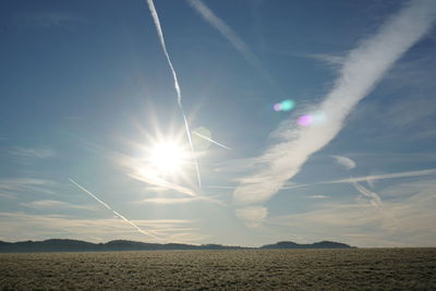 Scenic view of land against sky on sunny day