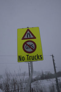 Road sign against sky