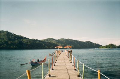 Pier over lake against sky